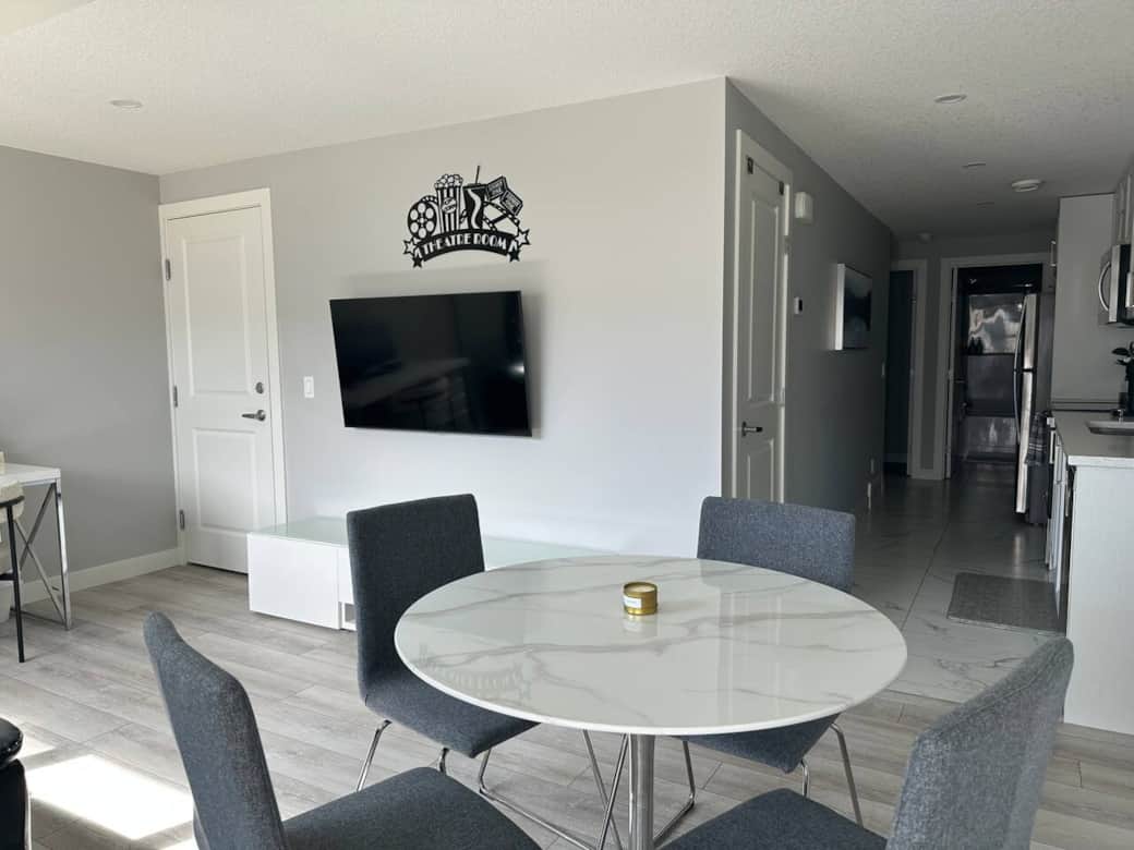 Bright and modern living space with a sleek Murphy bed, smart storage, a cozy desk setup, and comfortable seating. Perfect for relaxing, working, or enjoying a quiet night in.