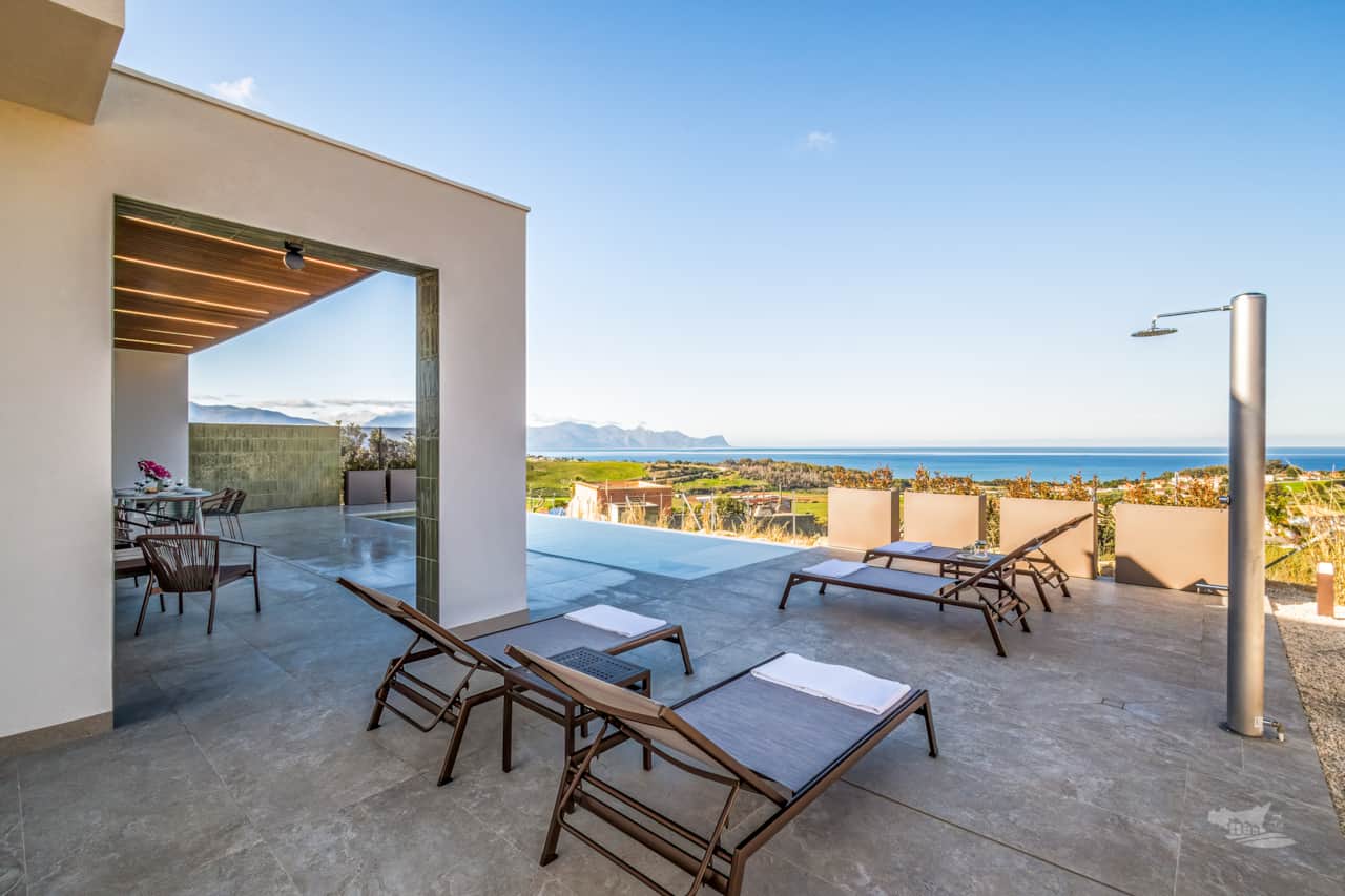 Luxury outdoor area with infinity pool, breathtaking sea views and stylish shaded veranda.