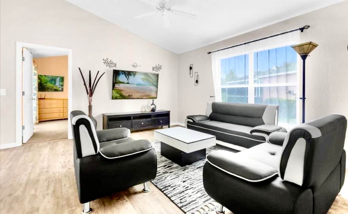 Very modern living space with large tv  and access to the pool 