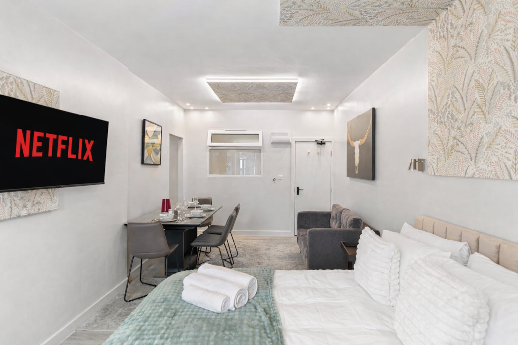 A modern dining space with a sleek table set for four, perfect for shared meals. A modern dining space with a sleek table set for four, perfect for shared meals.