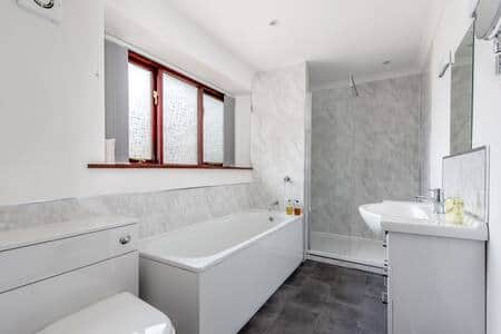 Bathroom with bath and shower