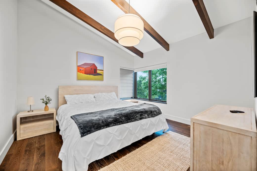 Elegant, modern mountain decor creates a peaceful sanctuary in the primary bedroom.