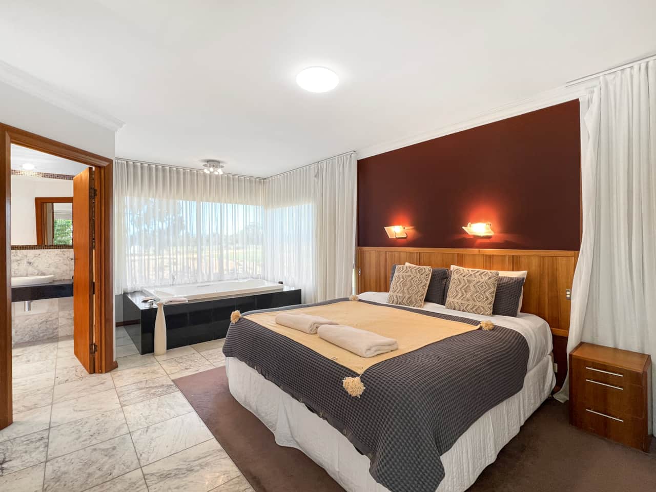 Relax in our cozy bedroom with a private bathtub for a truly indulgent stay.