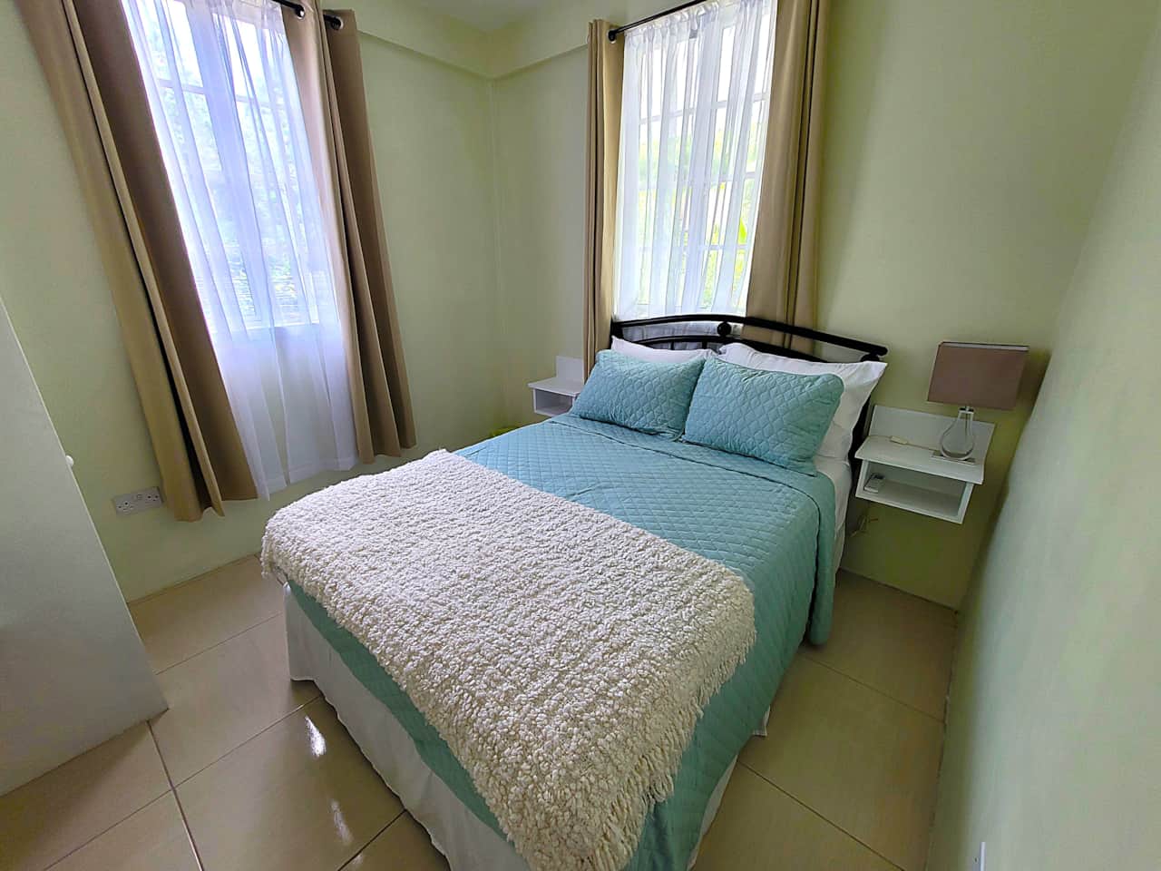 4 Bright double bedroom with high-quality linens and large windows at Garden View Apartments.