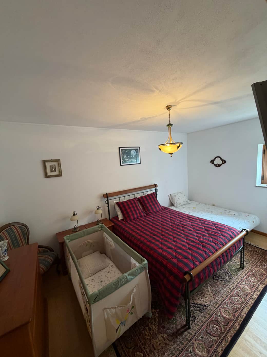 Room with double bed ,sofa-bed open and crib.