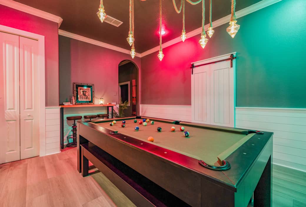 The dining table transforms into a full-size pool table, perfect for colorful game nights . The dining table transforms into a full-size pool table, perfect for colorful game nights .