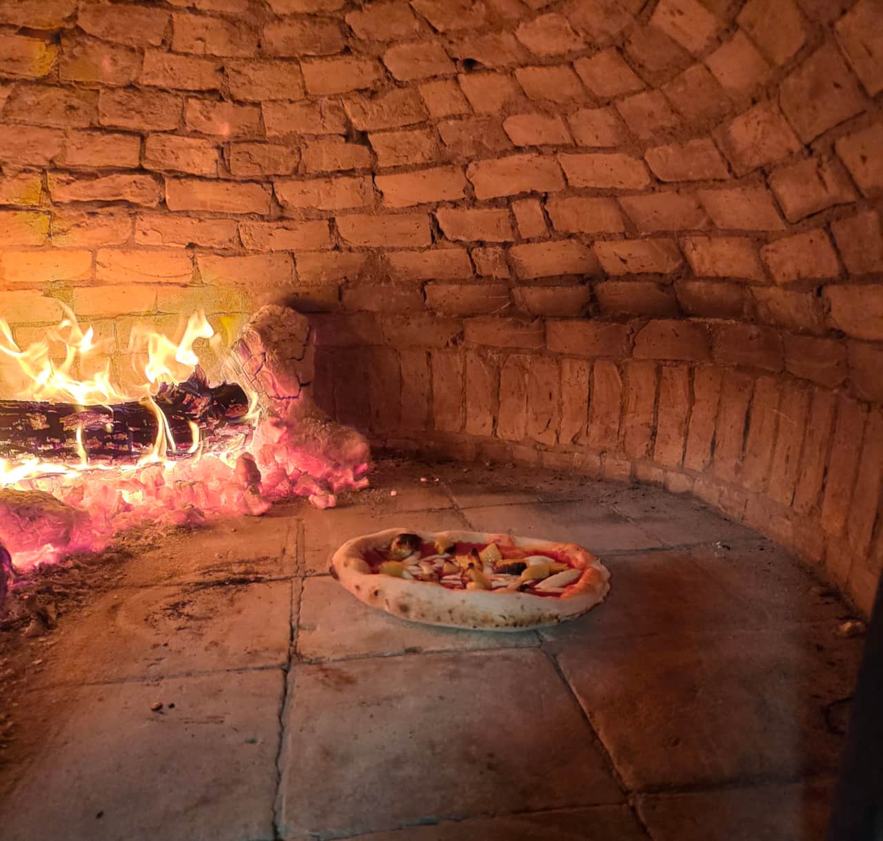 Wood-fired stone oven ready for outdoor cooking
