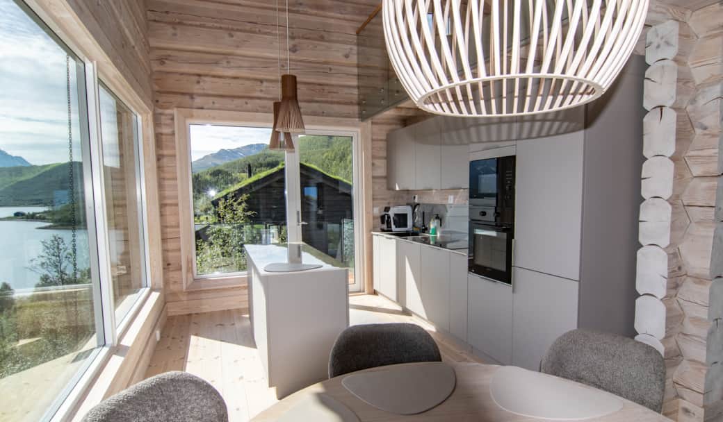 Nordlys open-plan interior with floor-to-ceiling windows facing the fjord Nordlys open-plan interior with floor-to-ceiling windows facing the fjord
