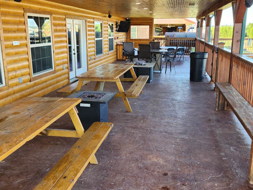 Community pool shaded patio area with picnic tables for snack time or taking a break from the sun