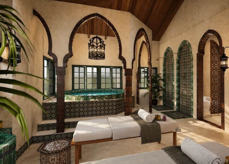 Moroccan inspired private spa with carved arches, side-by-side massage tables and hot tub