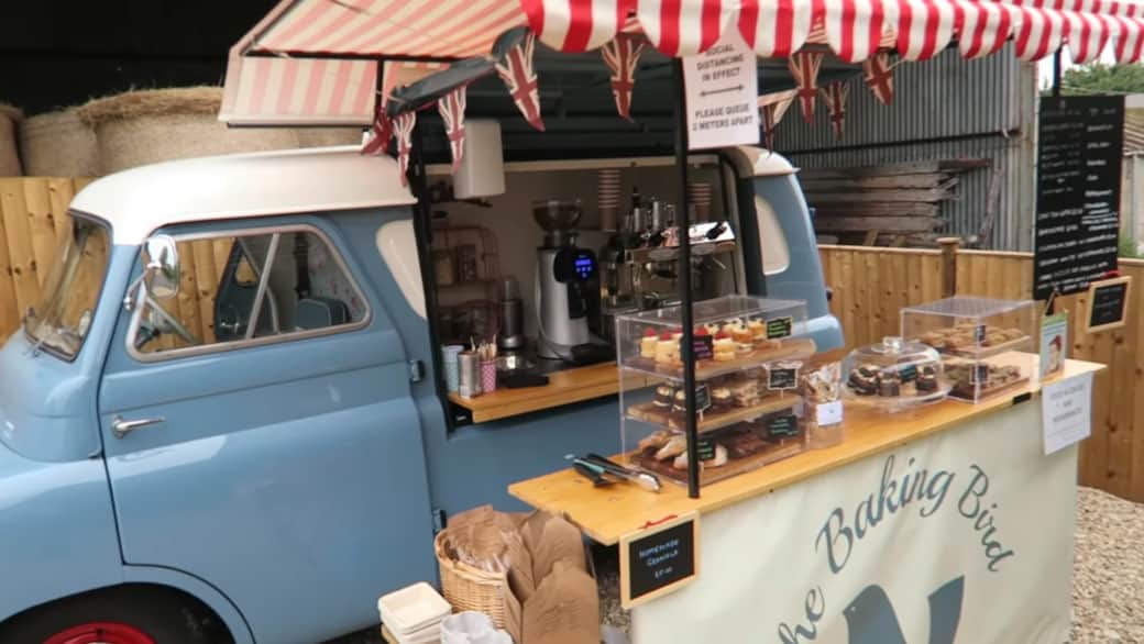 The Baking Bird vintage blue van serving coffee and cakes at Coombe Hill Farm Shop