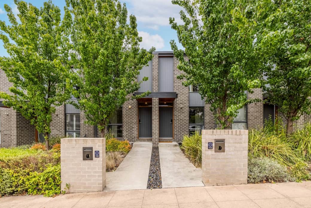 Your journey begins with a picturesque approach to our home. Flanked by vibrant trees and enclosed by a tasteful fence, the entrance exudes a sense of warmth and security. The symmetrical design and the inviting pathway make for a grand entrance.