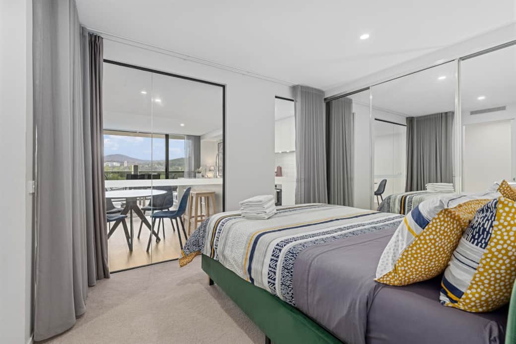 This bedroom not only offers a comfortable bed but also direct access to a balcony. The room is bathed in natural light, creating a bright and inviting space. It's an ideal spot for morning coffee or late-night reading, enhancing your stay. This bedroom not only offers a comfortable bed but also direct access to a balcony. The room is bathed in natural light, creating a bright and inviting space. It's an ideal spot for morning coffee or late-night reading, enhancing your stay.