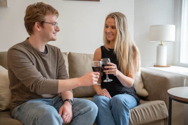 A couple relaxing with a glass of wine in a Lonsdale House apartment