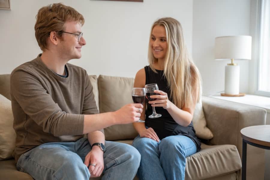 Couple relaxing with a glass of wine in a Lonsdale House apartment