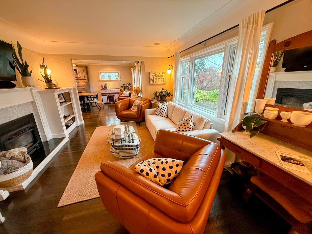 Main living room with leather, antiques, and a firm queen sofa bed (sleeps 2).