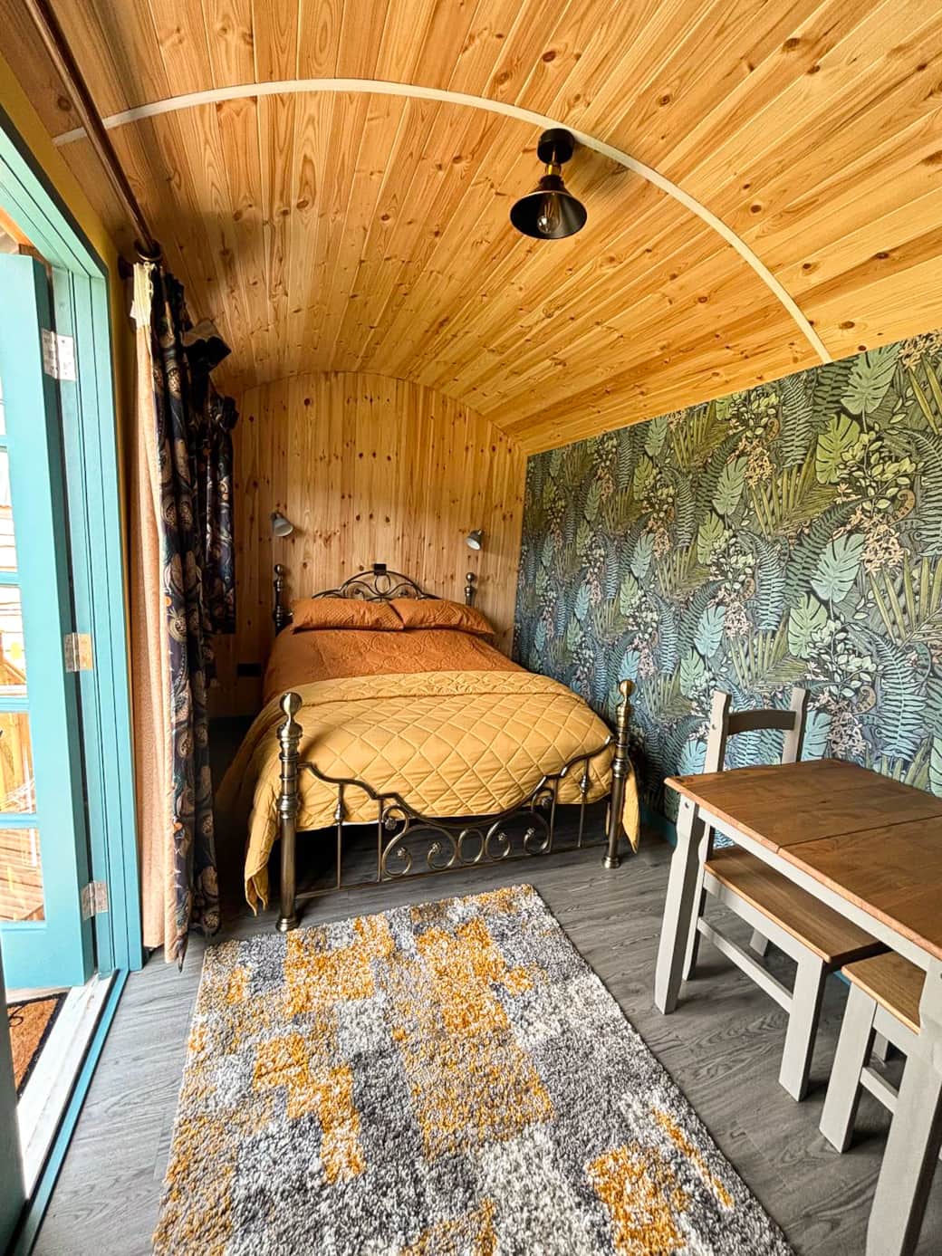 Cosy bedroom with warm timber finishes and nature-inspired décor.