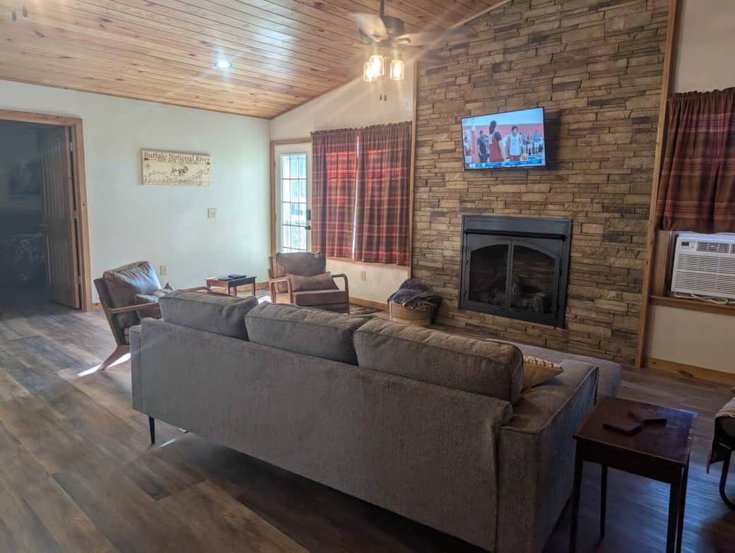 living room with couch, arm chairs, gas fireplace (turned off in summer) and Fire TV. 