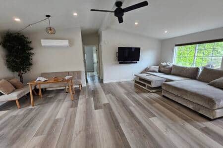 Open space design with living room, dining room, and hallway.
