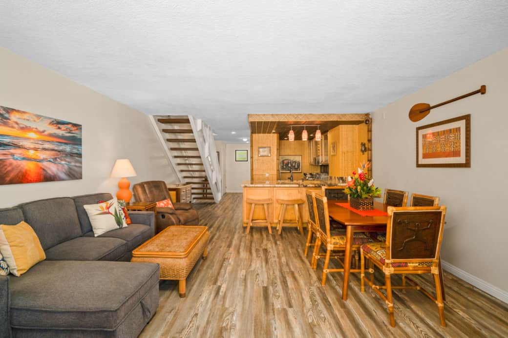 Relax, dine, and gather in this open living and dining space with tropical design, bamboo accents, a