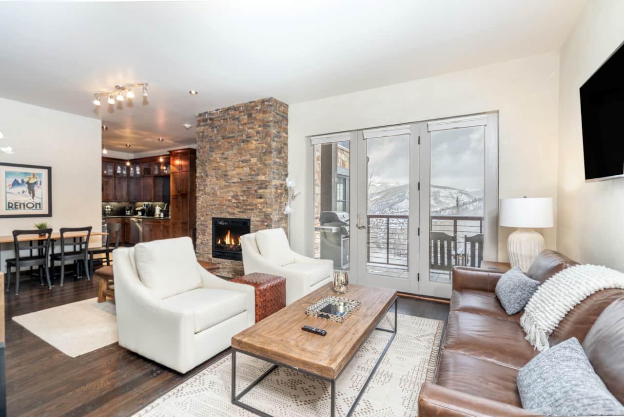 Living room seating area with open floor plan, deck access and unobstructed mountain views