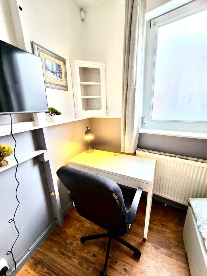 Bedroom has a work desk with drawers, storage and desk lamp for convenience. Room is bright from the window Bedroom has a work desk with drawers, storage and desk lamp for convenience. Room is bright from the window