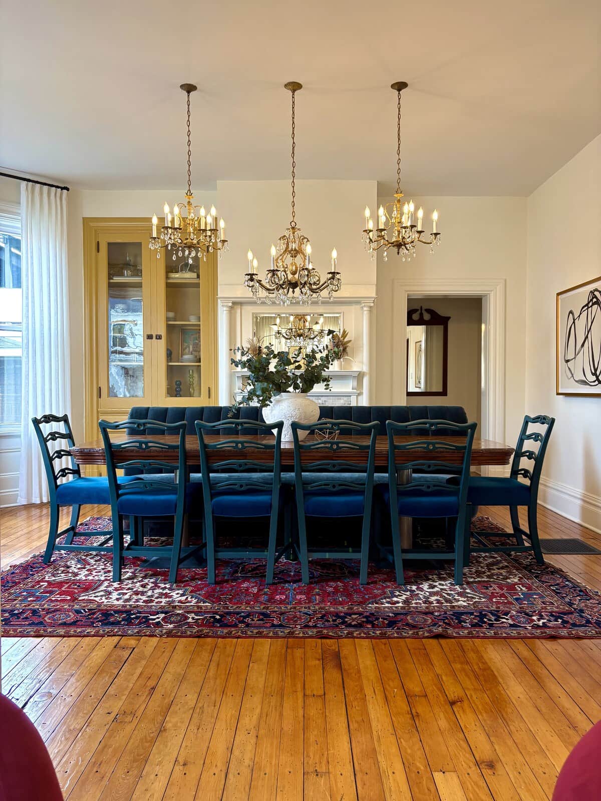 The dining room, set for everyone — a table long enough to seat the whole group at once