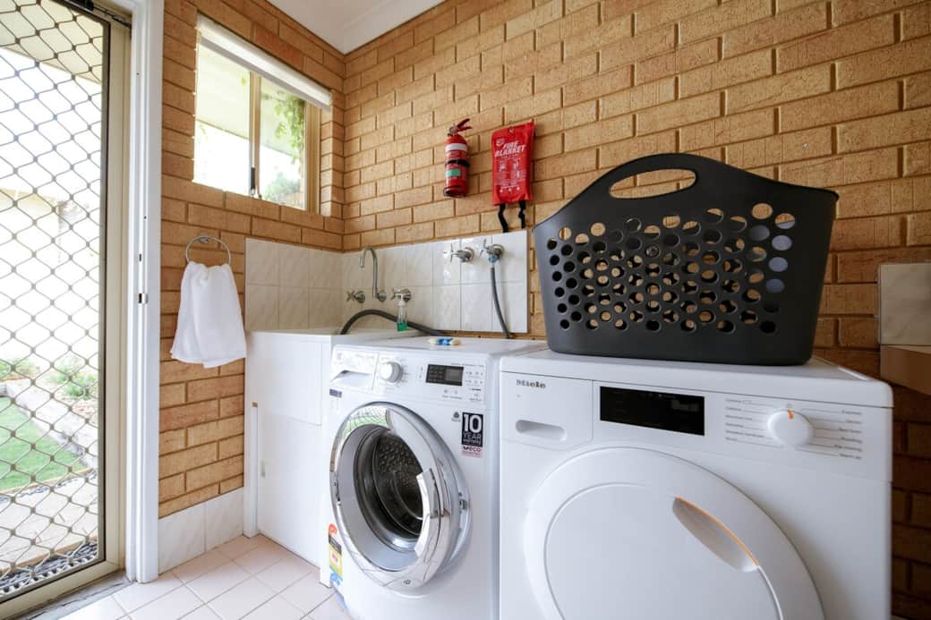 Laundry amenities: Washer, dryer, ironing board & iron, stick vacuum. Plus, an outdoor wall-mounted line. Washing pods & stain remover are on the windowsill; add pods directly with clothes.