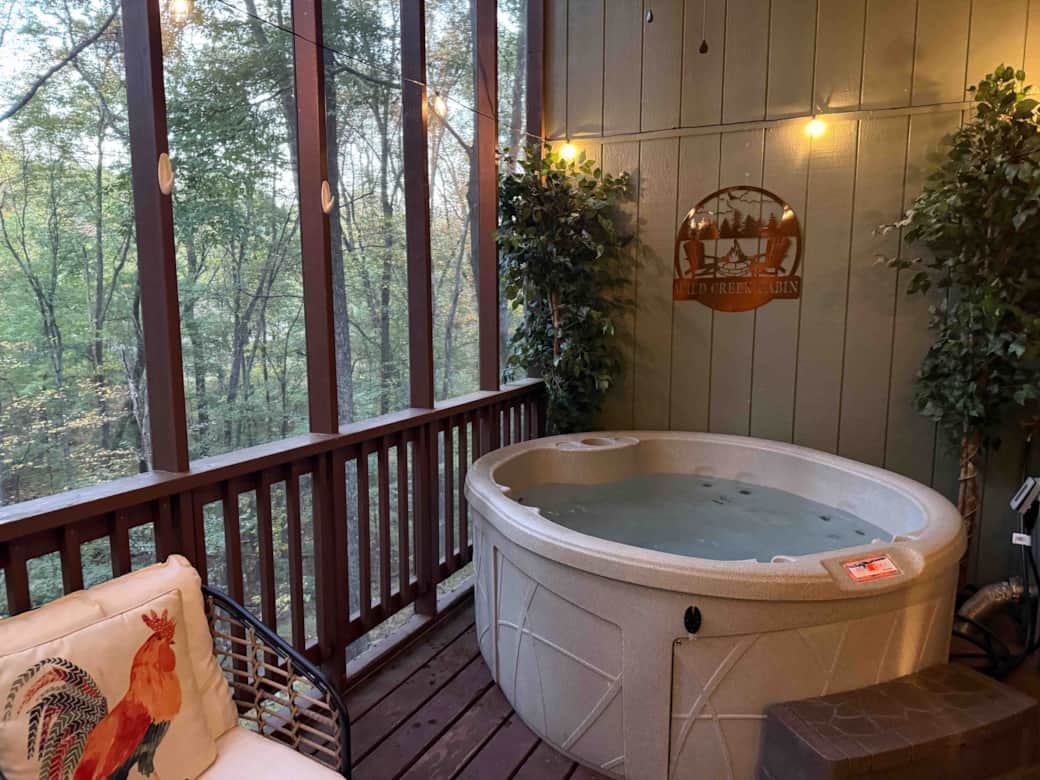 The porch overlooks a small stream that runs behind the cabin.