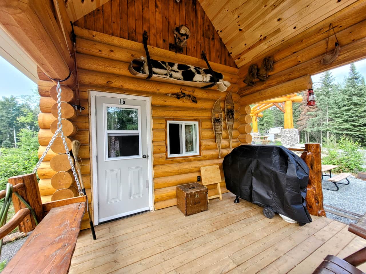 Trapper Bunkie Site 15 - covered deck with BBQ, log swing, water hose (city water)