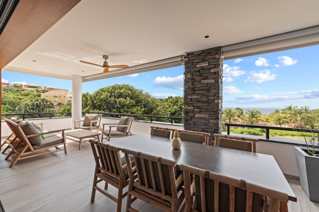 Spacious balcony with sea views, ceiling fan and sun blinds