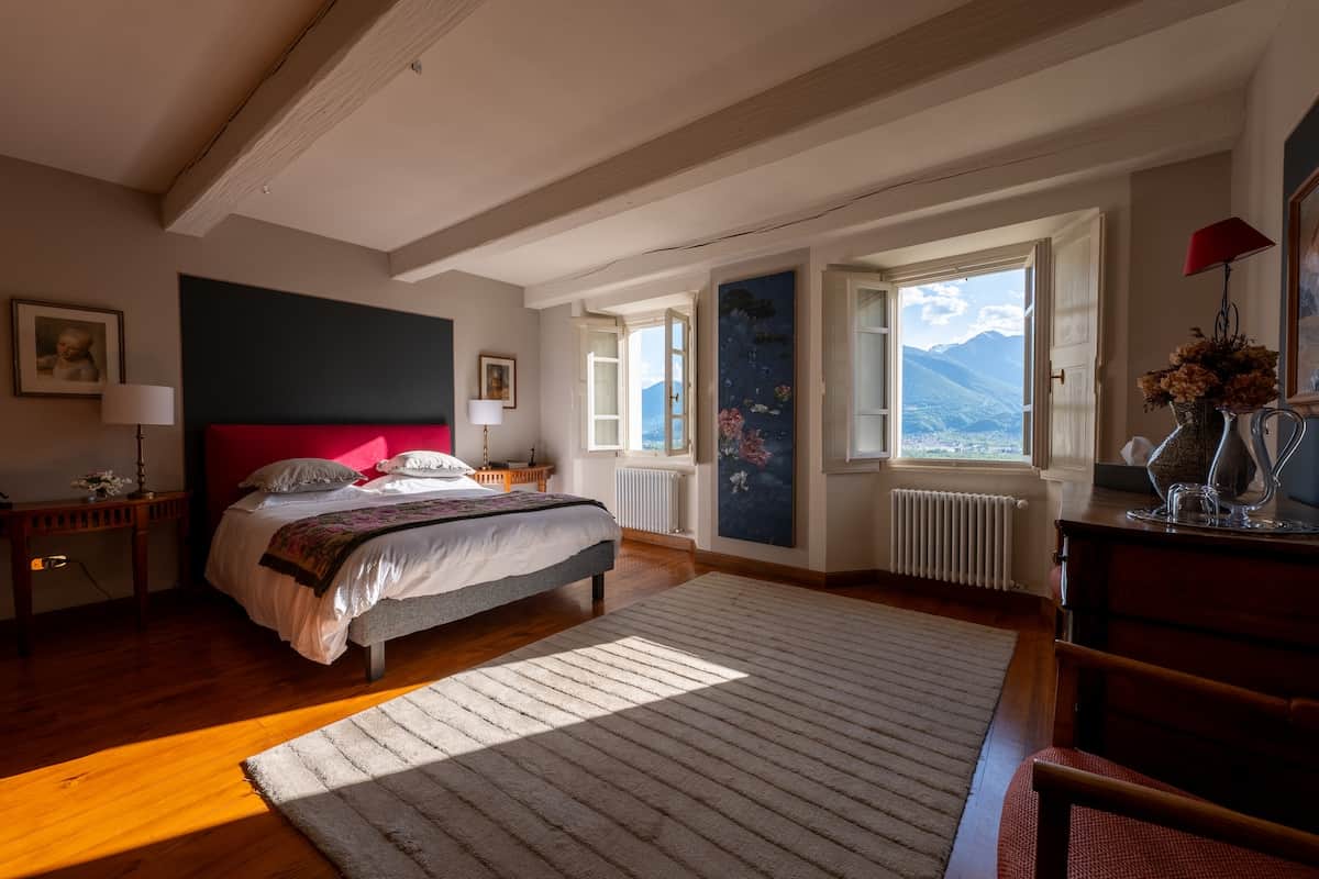 The spacious 25 m² bedroom with wooden flooring and exposed beams. 