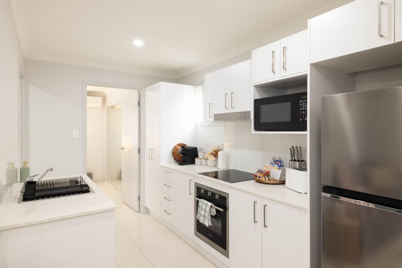 Kitchen: Sleek kitchen with ample storage, modern appliances 