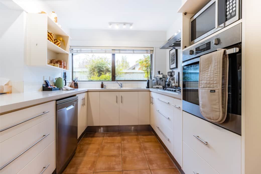 Fully equipped kitchen with modern appliances, air fryer, rice cooker, and dishwasher.