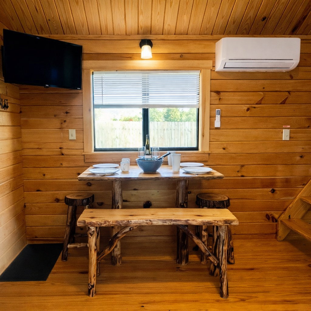 Rustic cabin dining area with sunlight Rustic cabin dining area with sunlight