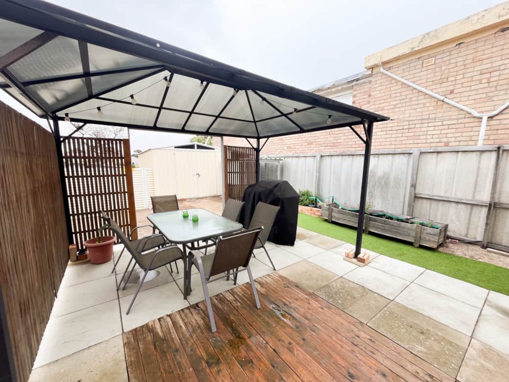 Enjoy private outdoor dining with a BBQ, pizza oven, and covered entertaining area
