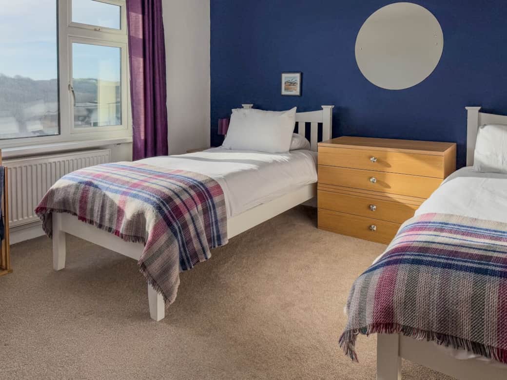 Twin room with comfy beds,  clothes hanging and amazing views. 