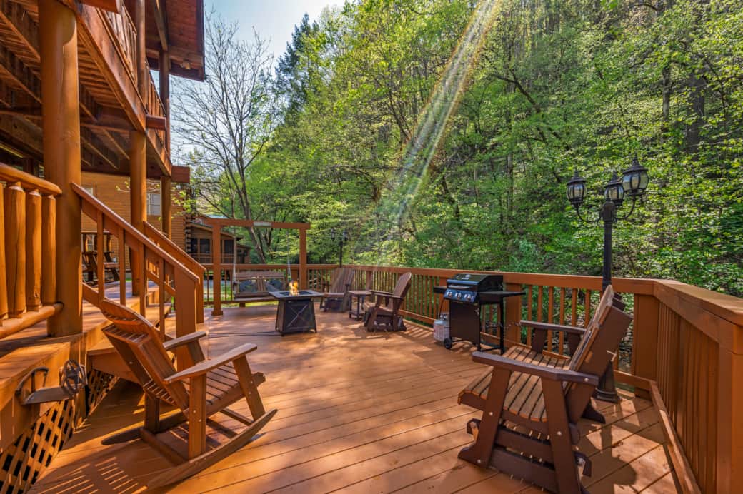 All the ingredients for a perfect evening: swing, glider, fire pit, and the soothing creek nearby.