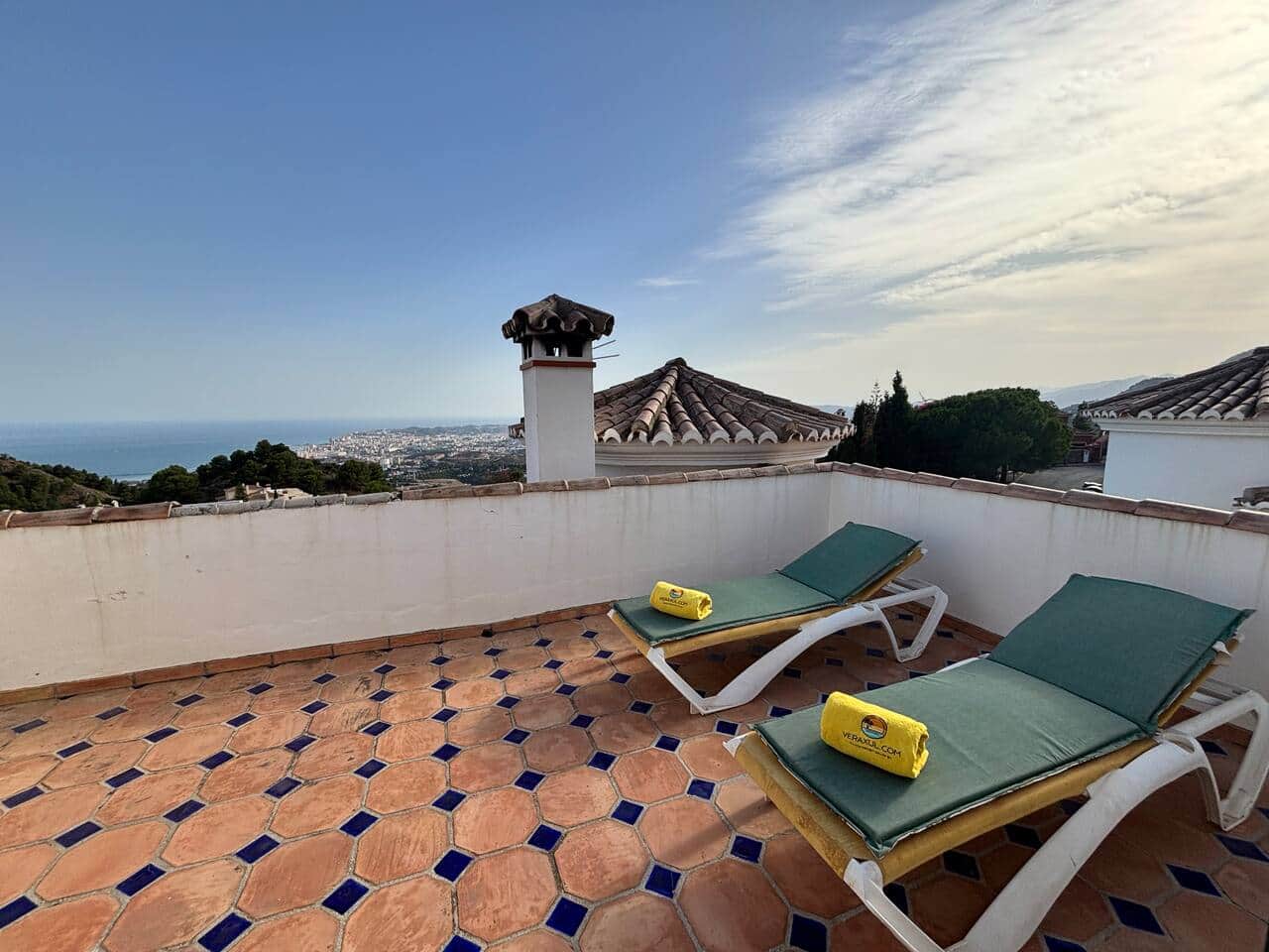 Private rooftop terrace with sun loungers and panoramic views.