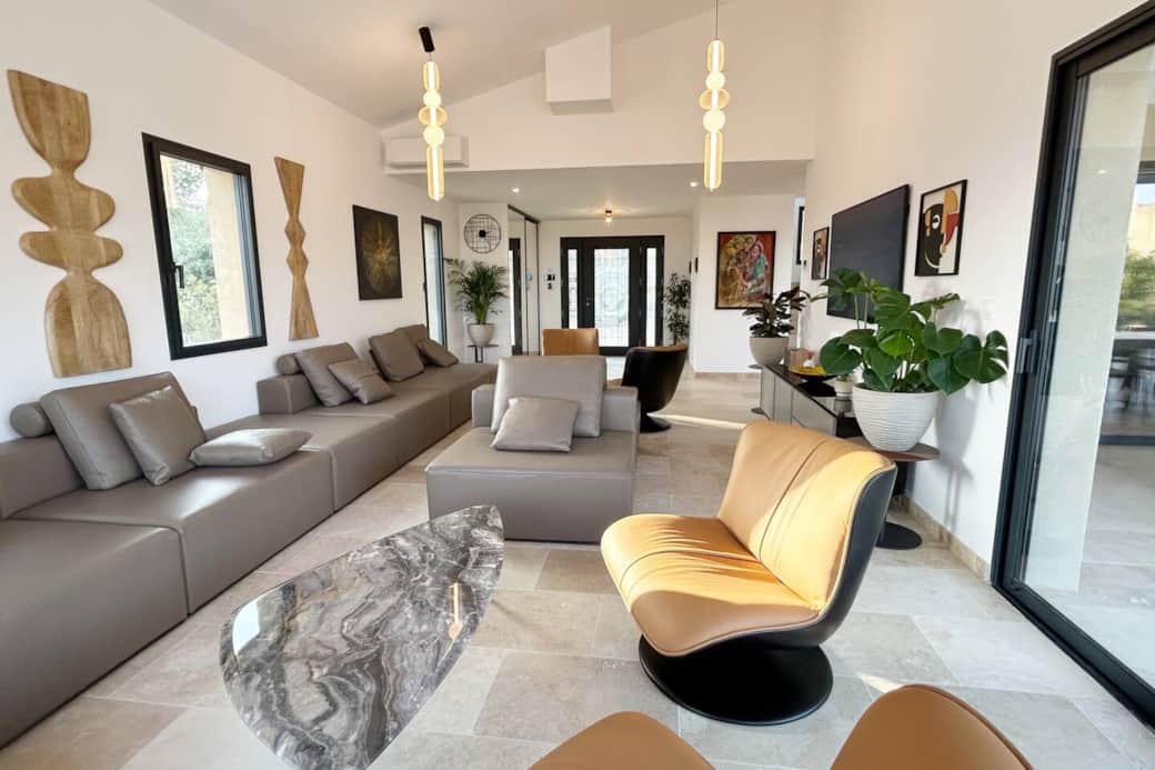 Bright living room seating for 12 with large screen TV and open to the mountain.