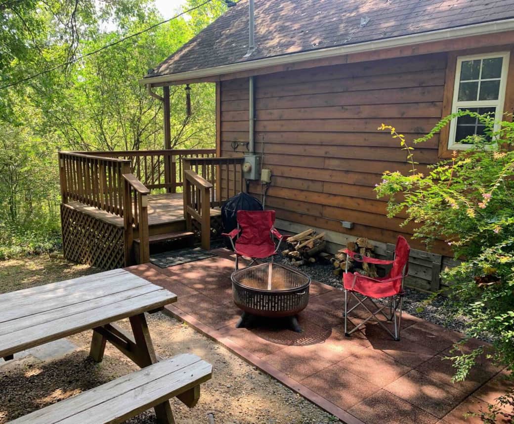 outdoor patio area with fire pit, camp chairs and picnic table (4 camp chairs kept at cabin)