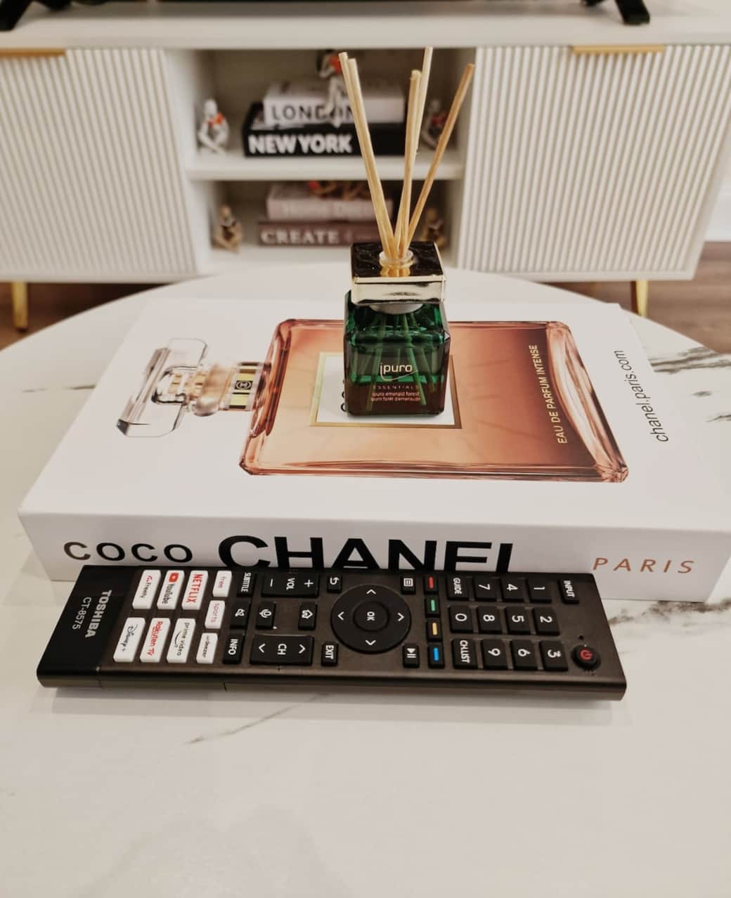 Stylish coffee table with reed diffuser and modern décor.