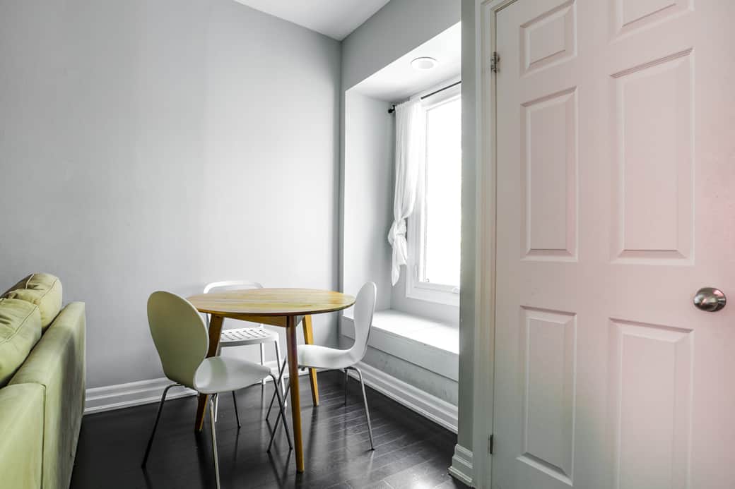 Warm and inviting dining space in a short-term rental, with a compact table set .