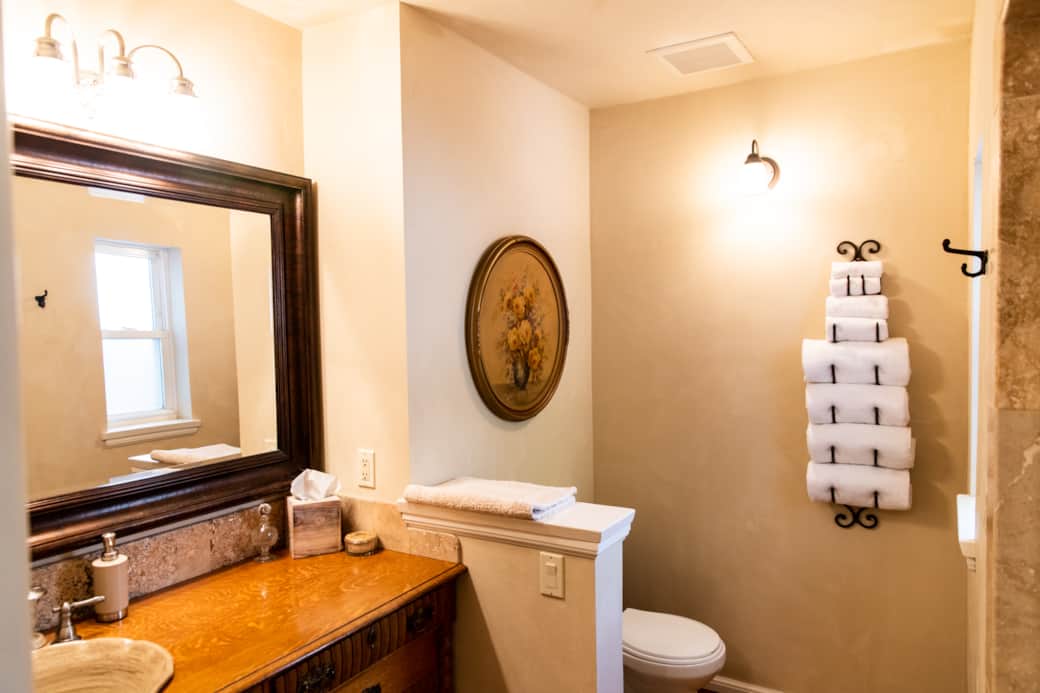 Bright bathroom with plush towels and antique-chic details Bright bathroom with plush towels and antique-chic details