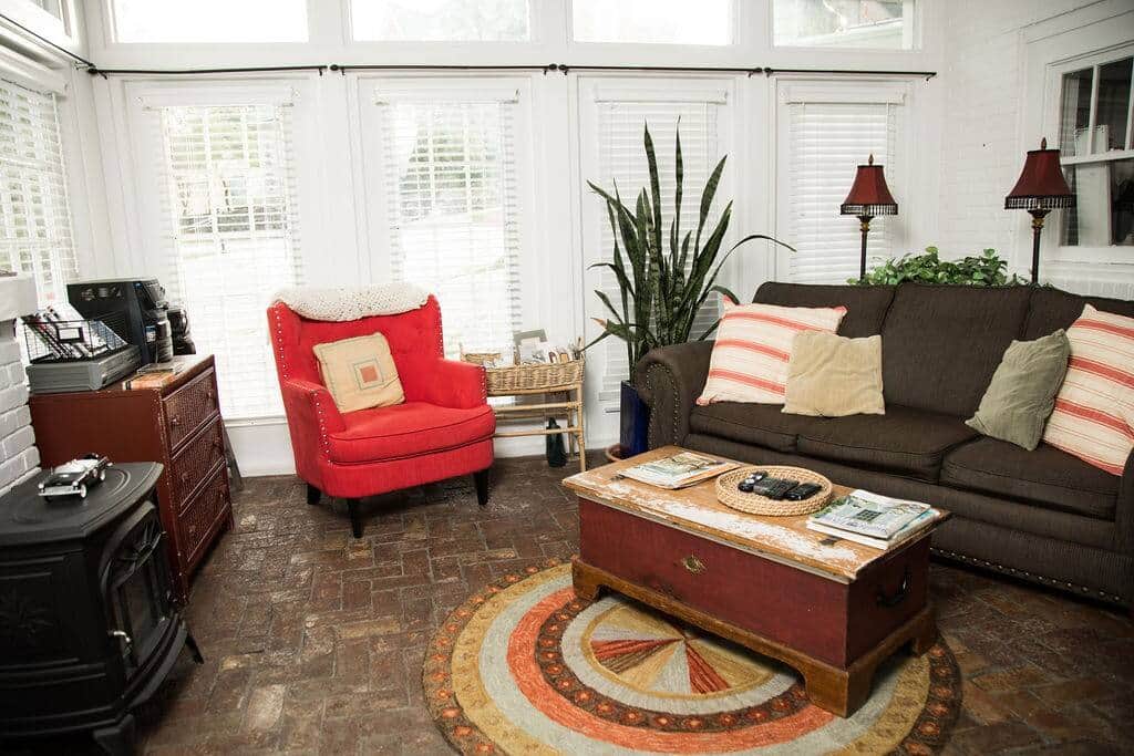Beautiful living area with gorgeous natural light and original brick flooring.