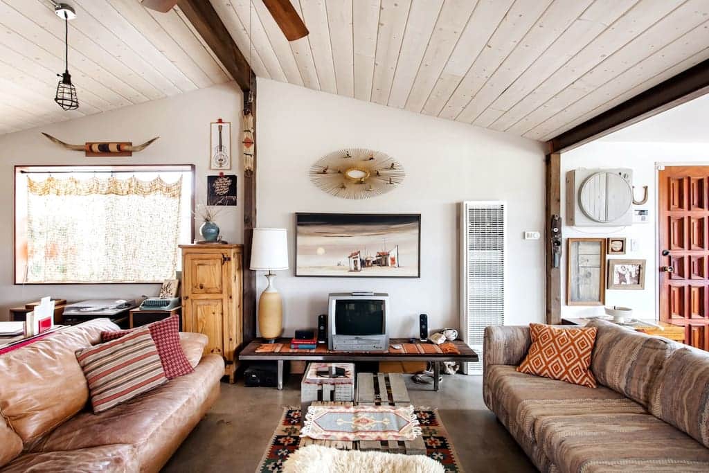 The living room is brimming with artful décor and a large open space.