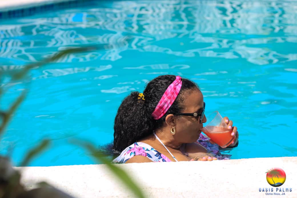 Guest enjoying Oasis Rum Punch