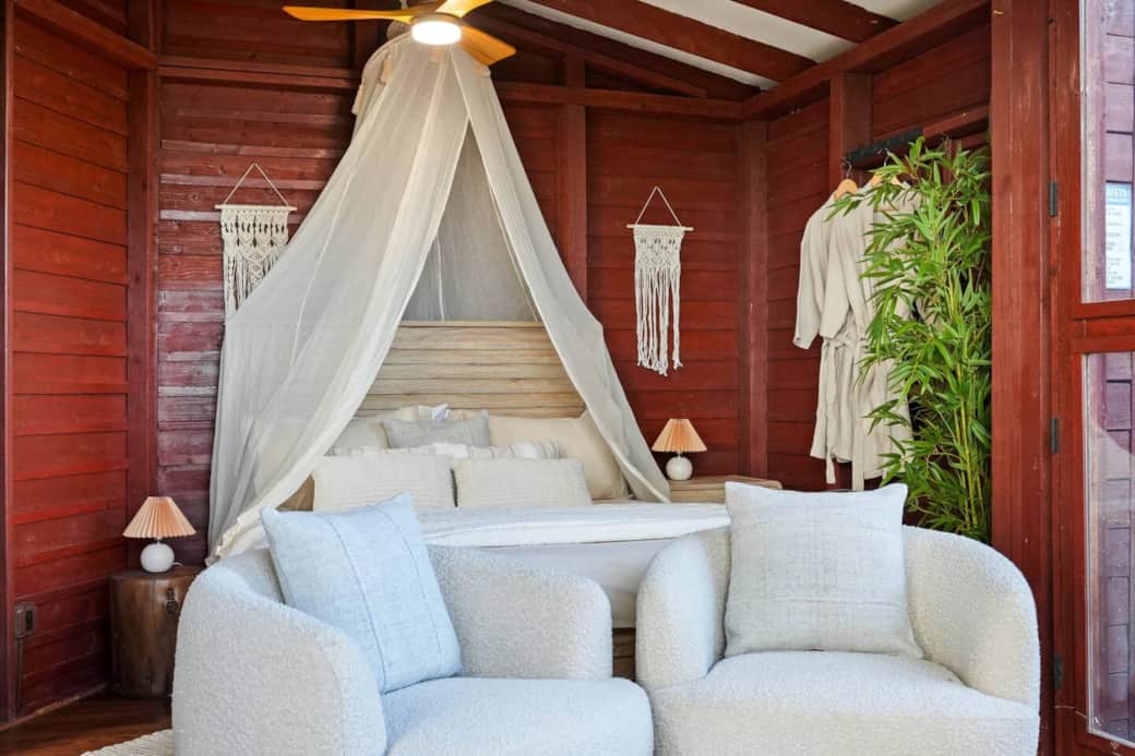 Cozy living room next to the bedroom with a canopy bed and comfortable seating. Cozy living room next to the bedroom with a canopy bed and comfortable seating.