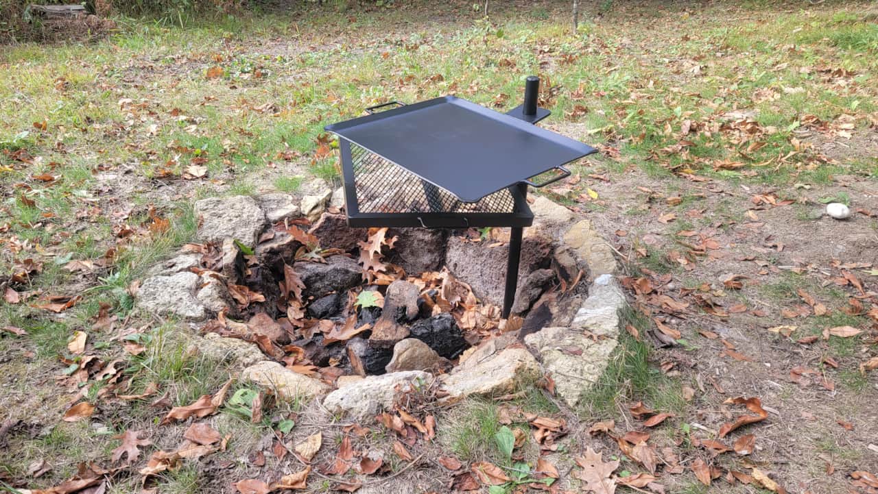 Private firepit with cooking grate and skillet