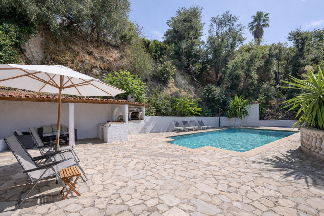 Mediterranean poolside retreat with lounge area